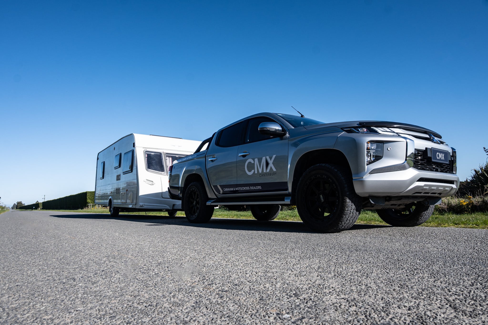CMX Canterbury ute towing a caravan on a country road